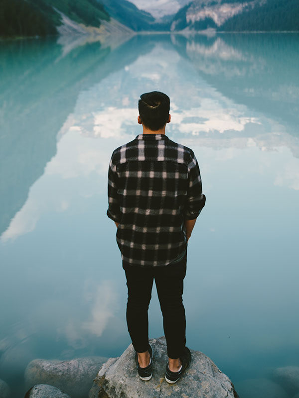 Man looking at reflection in water
